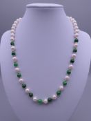 A pearl and jade necklace with a 14 ct gold clasp. 46 cm long.