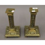 A pair of Victorian pierced brass candlesticks. Each 23.5 cm high.