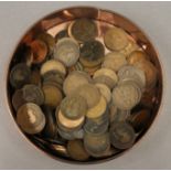 A large collection of British pennies in a farthing tin.