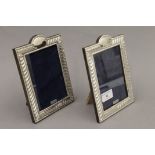 A pair of silver photograph frames. 19 cm high.
