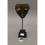 A replica BAFTA trophy, together with a BAFTA mask stickpin and brooch. The former 37 cm high.