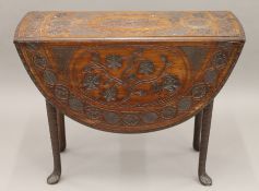 A Georgian mahogany carved drop leaf table. 93 cm deep.