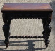 A Victorian carved oak card table. 91 cm wide.