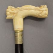 A walking stick with a carved bone handle formed as monkeys. 91.5 cm high.