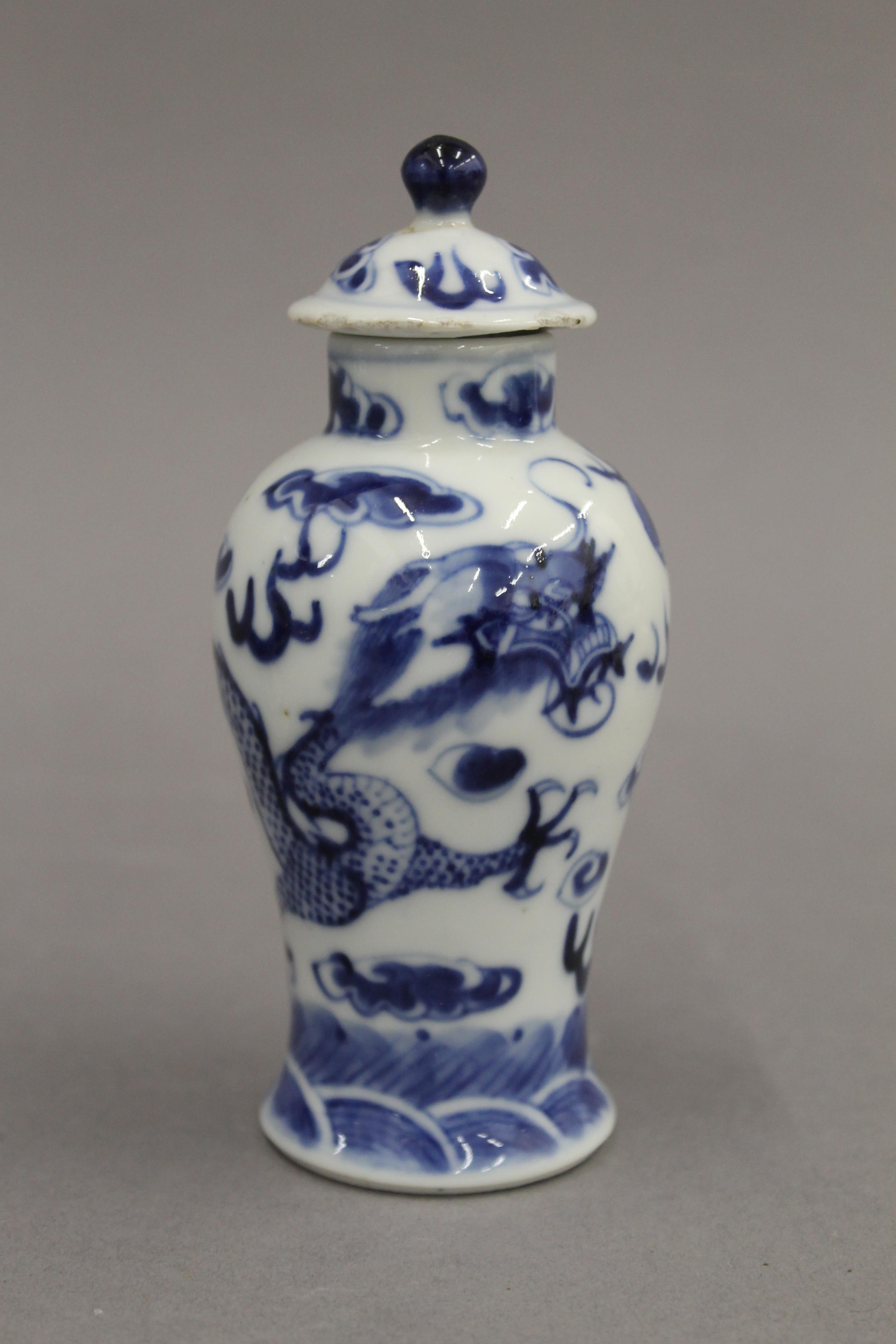 A pair of 19th century Chinese blue and white porcelain vases and covers, decorated with dragons. - Image 3 of 16