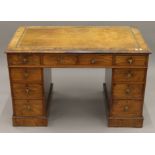 A Victorian walnut pedestal desk. 113.5 cm wide.