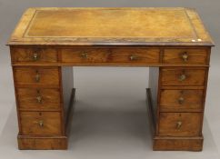 A Victorian walnut pedestal desk. 113.5 cm wide.