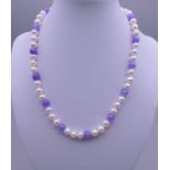 A 14 ct gold pearl and lilac jade necklace. Approximately 42 cm long.