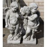 Two cherub garden statues.