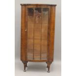 An early 20th century walnut display cabinet. 61 cm wide, 118.5 cm high, 34 cm deep.