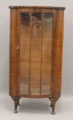 An early 20th century walnut display cabinet. 61 cm wide, 118.5 cm high, 34 cm deep.