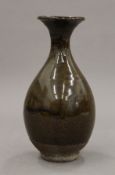 A small olive glazed pottery vase. 17 cm high.