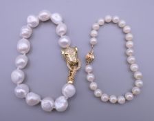 A pearl bracelet with a 14 K gold clasp and a pearl bracelet with a panther formed clasp.