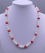 A 14ct gold pearl and coral necklace. Approximately 41 cm long.