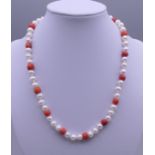 A 14ct gold pearl and coral necklace. Approximately 41 cm long.