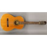 A Spanish acoustic guitar. 102 cm high.