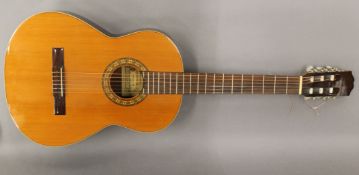 A Spanish acoustic guitar. 102 cm high.