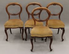 A set of four Victorian mahogany balloon back chairs. 48 cm wide.