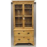 A Victorian pine glazed bookcase over drawers. 100.5 cm wide x 209 cm high.