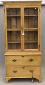 A Victorian pine glazed bookcase over drawers. 100.5 cm wide x 209 cm high.