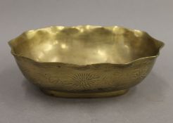 A Chinese oval brass bowl. 21 cm wide.