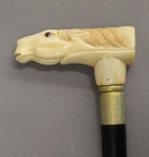 A walking stick with a carved bone handle formed as a horse. 90 cm high.