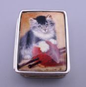A silver pill box depicting a cat. 2.5 cm wide.