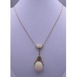 An 18 ct gold opal and emerald set drop pendant necklace. The pendant 5 cm high. 7.