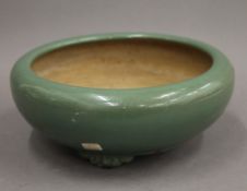 A Chinese celadon ground pottery bowl. 24 cm diameter.