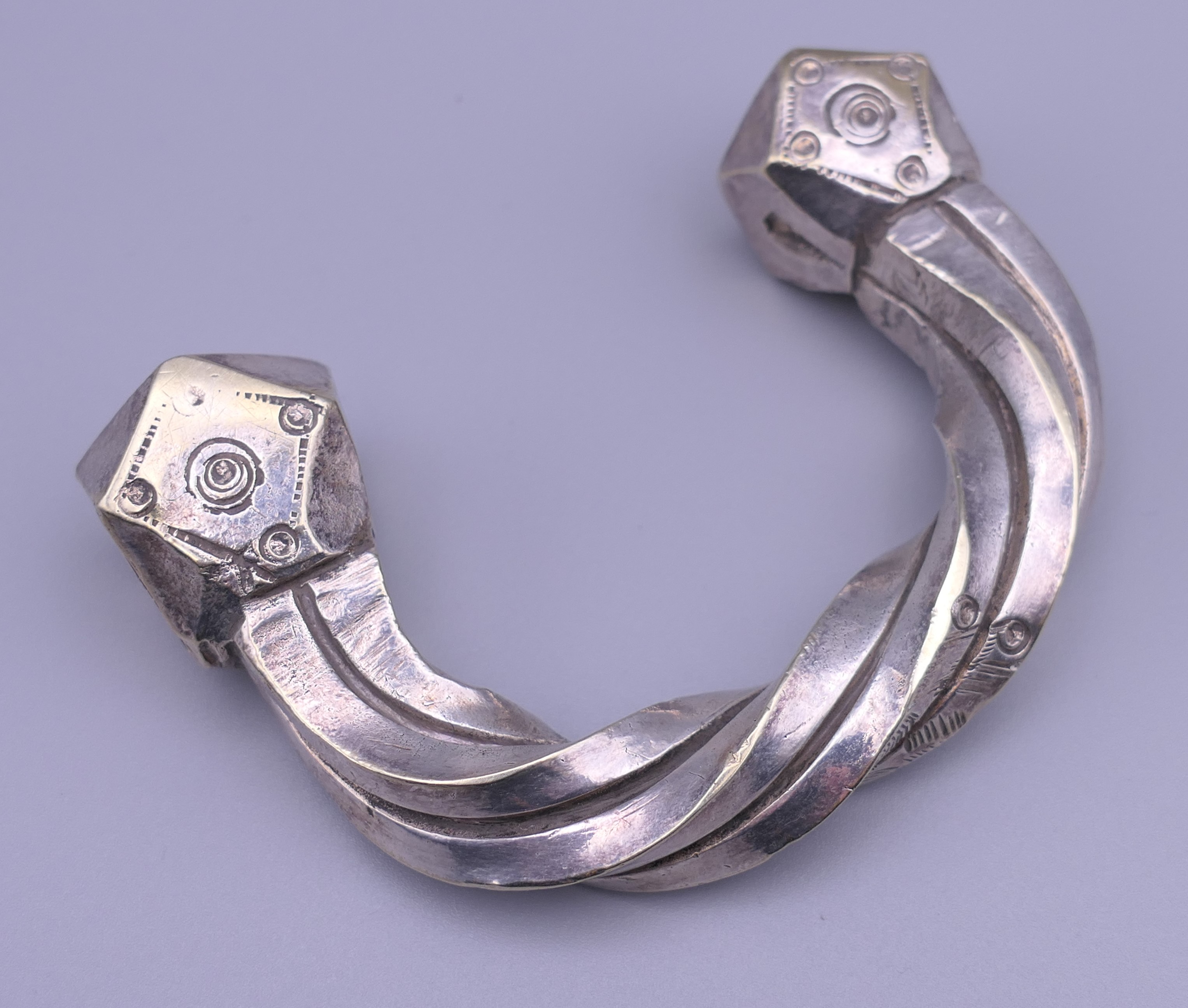 An Eastern silver plated torque. 9.25 cm wide.