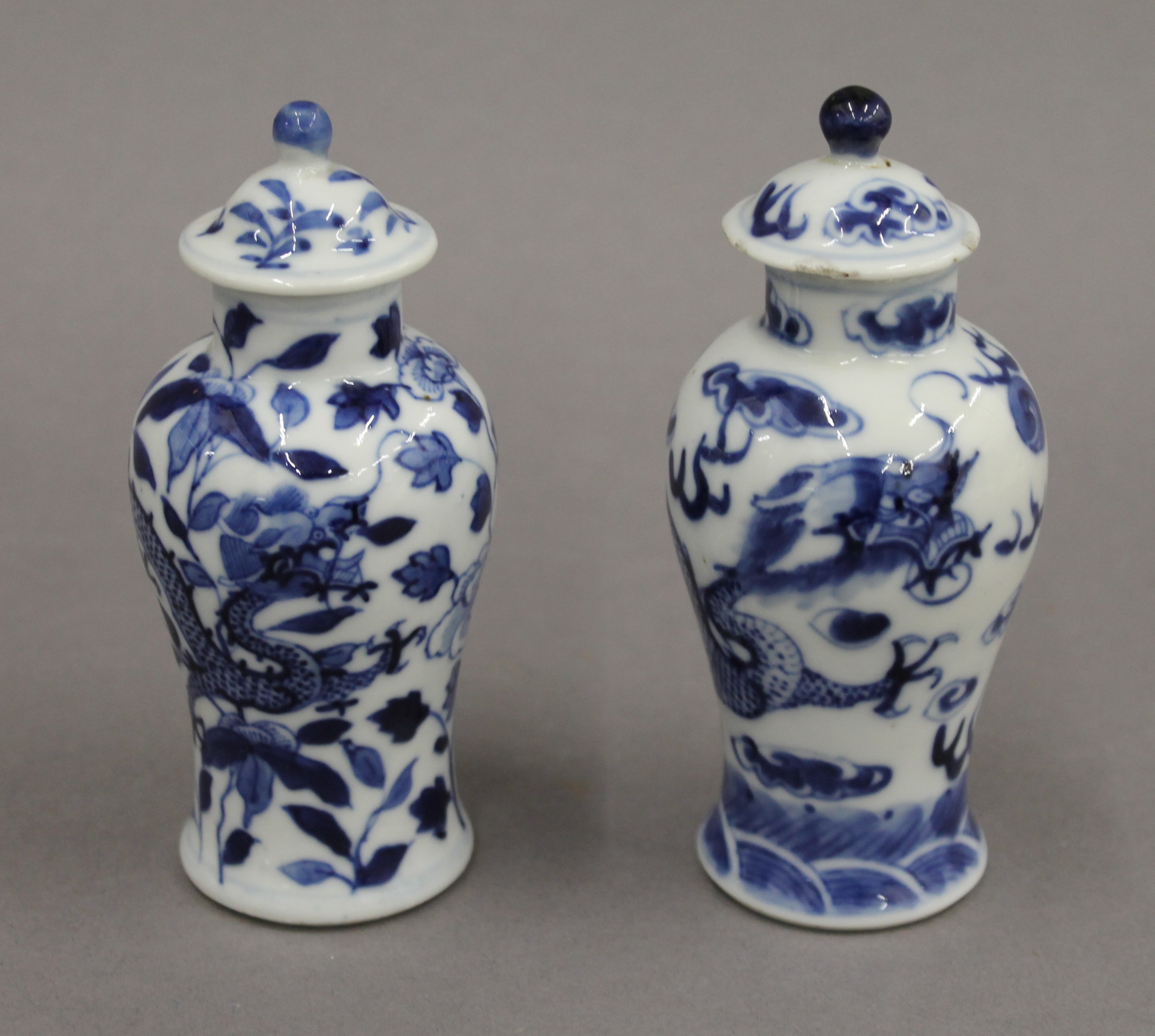 A pair of 19th century Chinese blue and white porcelain vases and covers, decorated with dragons.