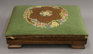 An upholstered oak foot stool