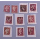 Ten Victorian penny red stamps.