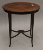 An Edwardian inlaid mahogany oval side table. 65 cm wide, 45 cm deep, 73 cm high.