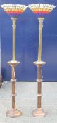 A pair of leaded brass uplighters on wooden stands. 190 cm high.