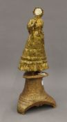 An early 20th century gilt bronze and ivory model of a young lady mounted on wooden plinth base.