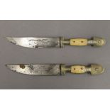 Two Eastern bone handled daggers, each with an engraved blade. The largest 23.5 cm long.