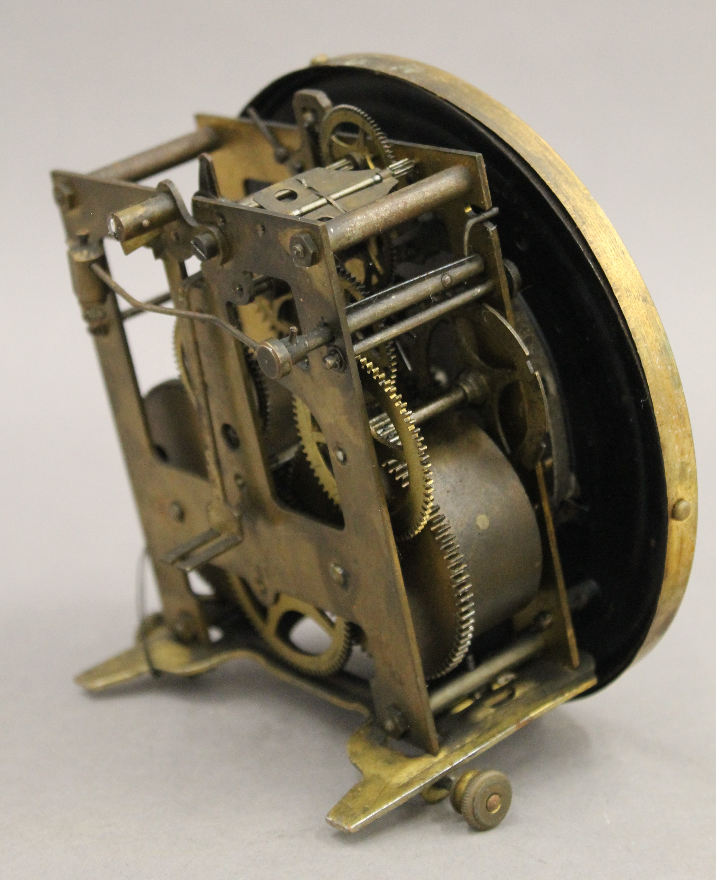 A clock movement and pendulum. 14.5 cm diameter. - Image 4 of 5