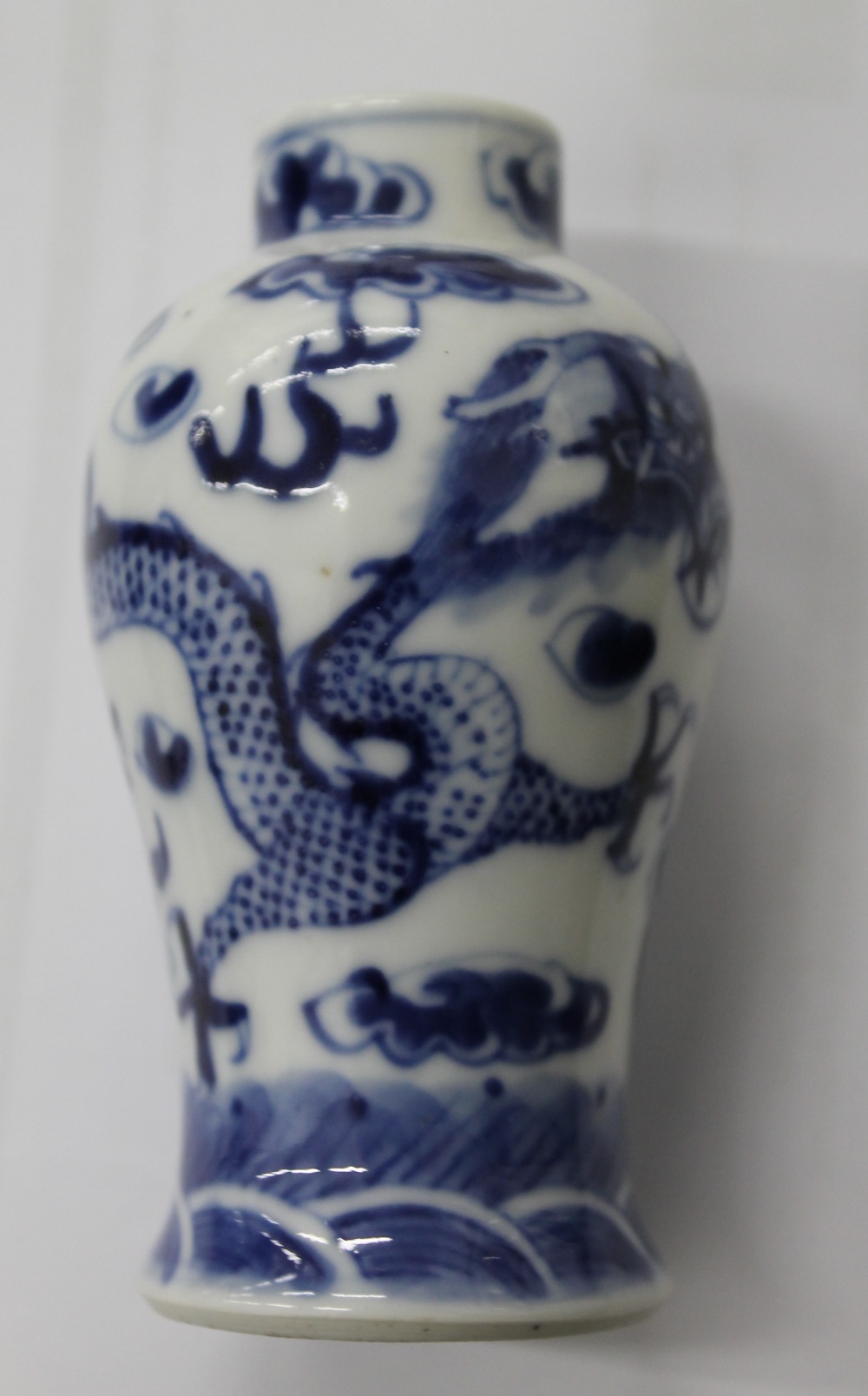 A pair of 19th century Chinese blue and white porcelain vases and covers, decorated with dragons. - Image 4 of 16