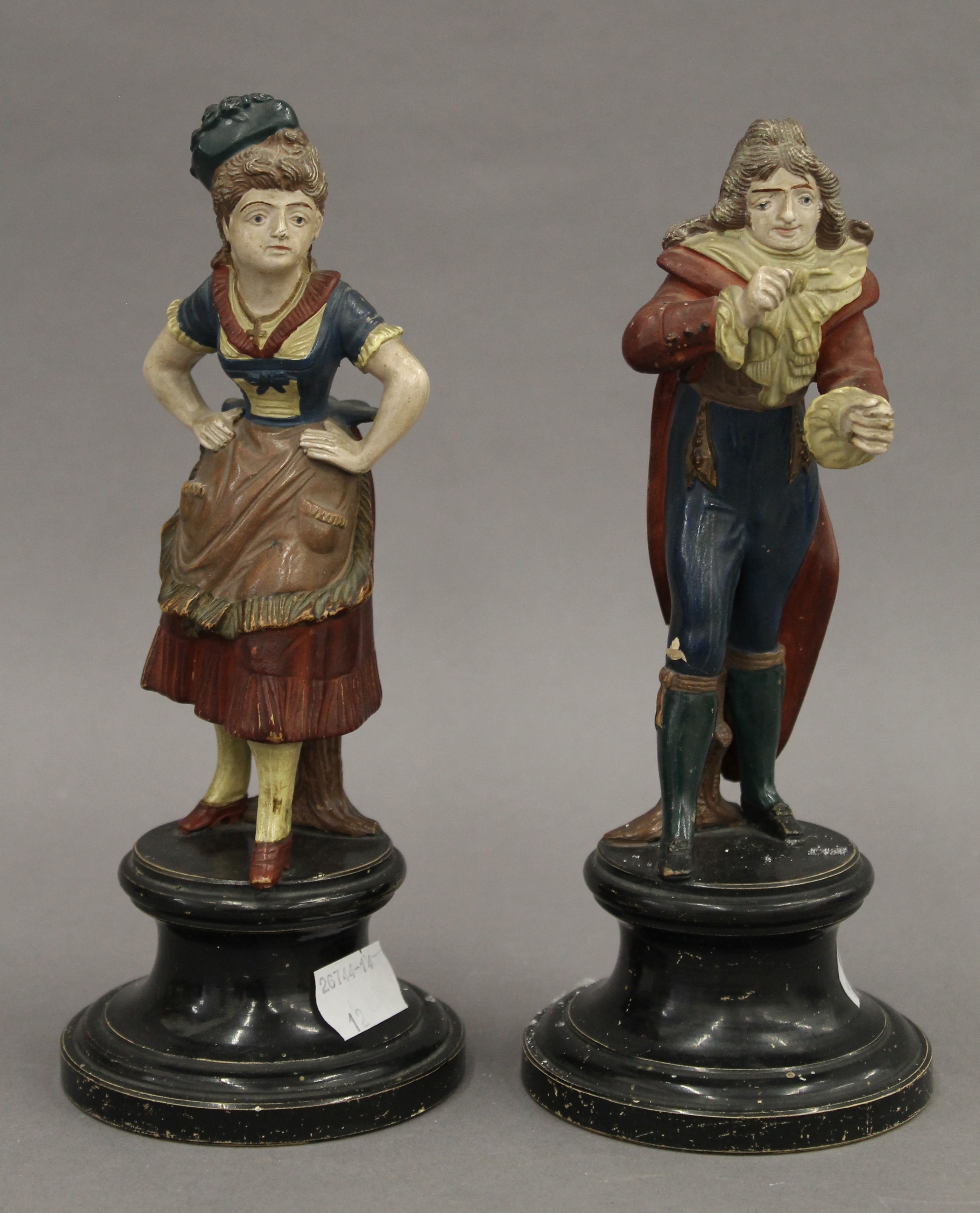 A pair of Continental pottery figures. The largest 21.5 cm high.