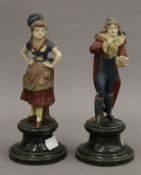 A pair of Continental pottery figures. The largest 21.5 cm high.