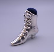A silver pin cushion in the form of a boot. 4 cm high.
