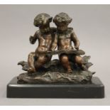 A marble based bronze model of two children writing. 13.5 cm wide.