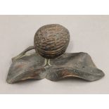 A Black Forest carved inkwell formed as a nut. 14 cm wide.