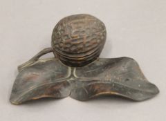 A Black Forest carved inkwell formed as a nut. 14 cm wide.