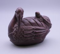 A carved wooden netsuke in the form of a water bird and turtle. 5 cm long.