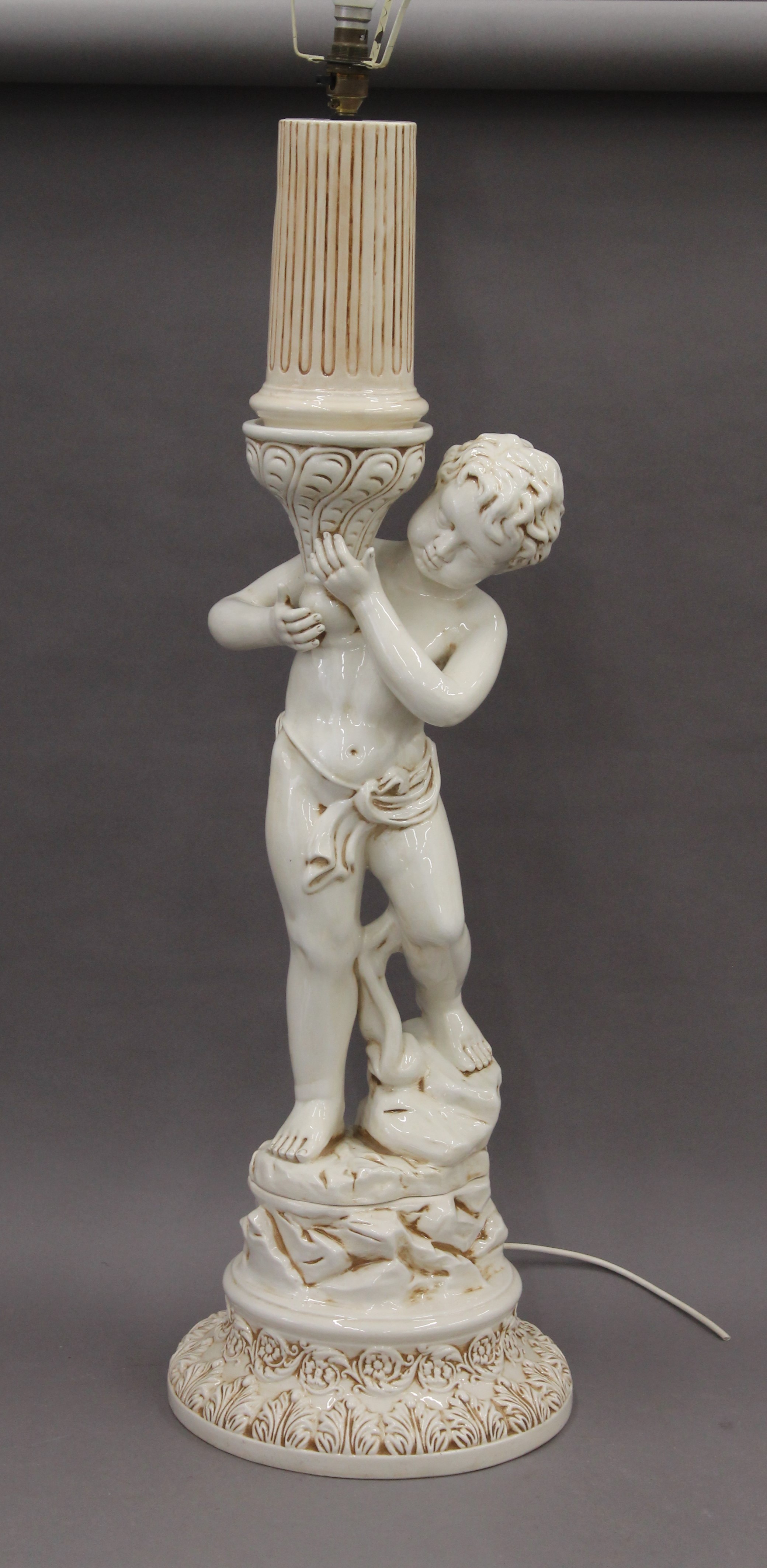 A porcelain figural lamp. 120 cm high overall.