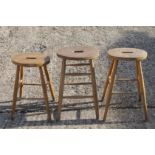 Three elm seated stools.