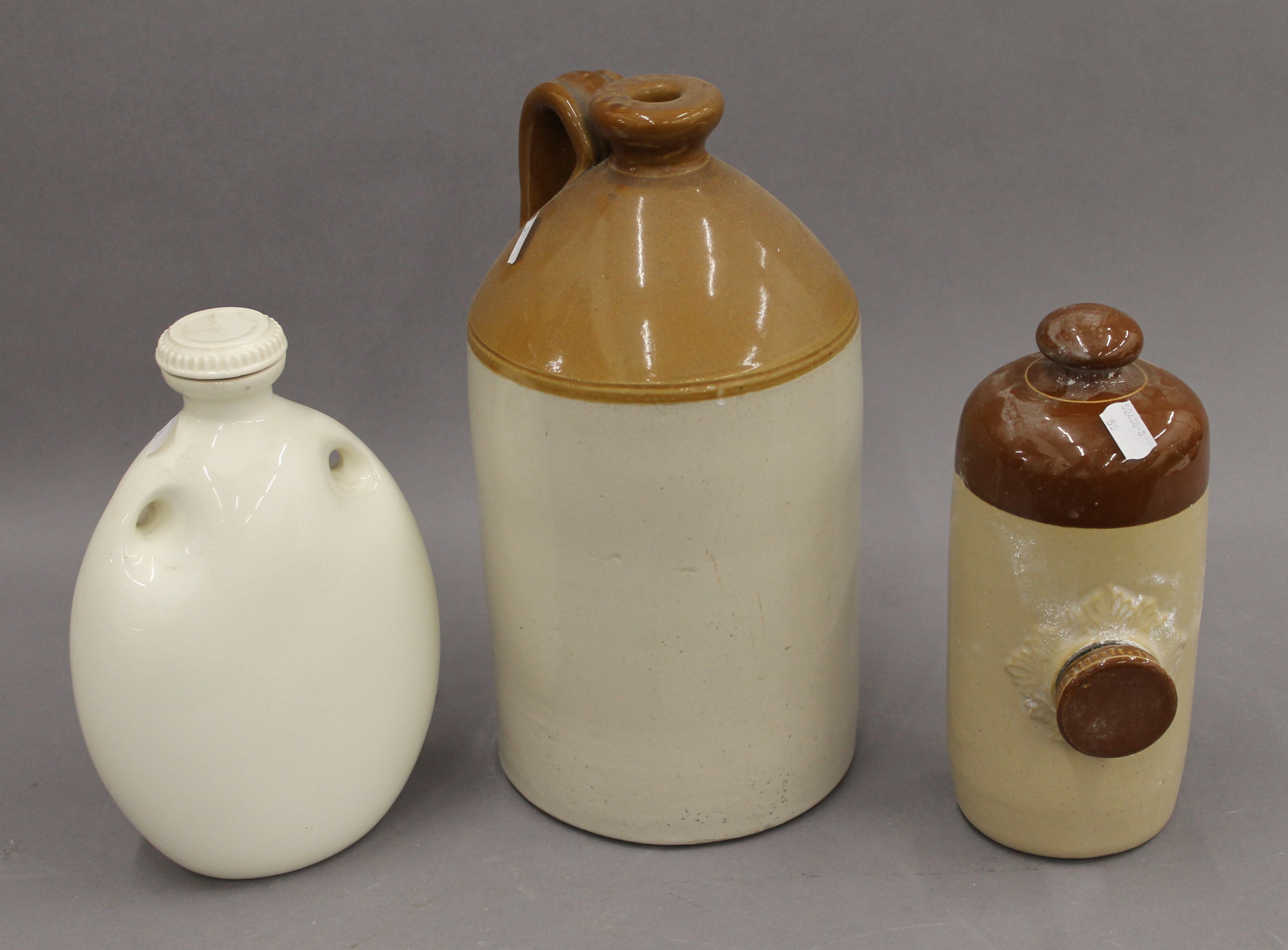 A Victorian stoneware flagon and two hot water bottles. The former 33 cm high.