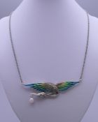 A plique a jour bird necklace. The pendant 8.5 cm wide.